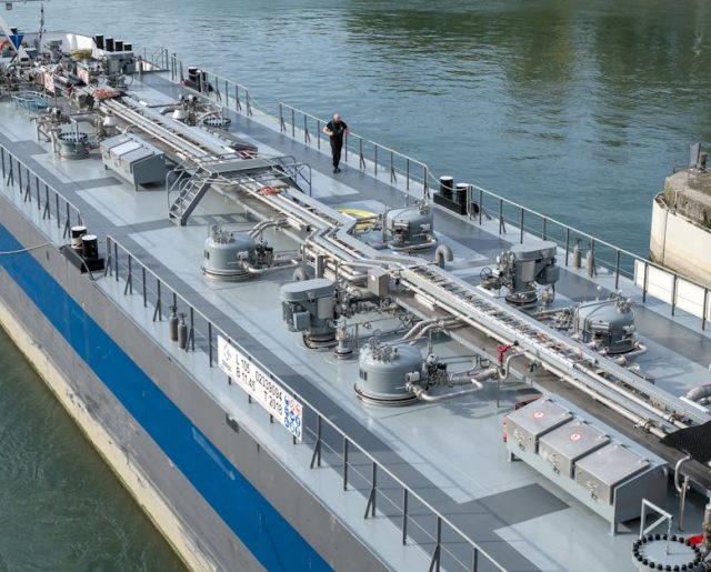 Aerial view of an industrial oil tanker docked at a harbor, showcasing modern maritime technology.